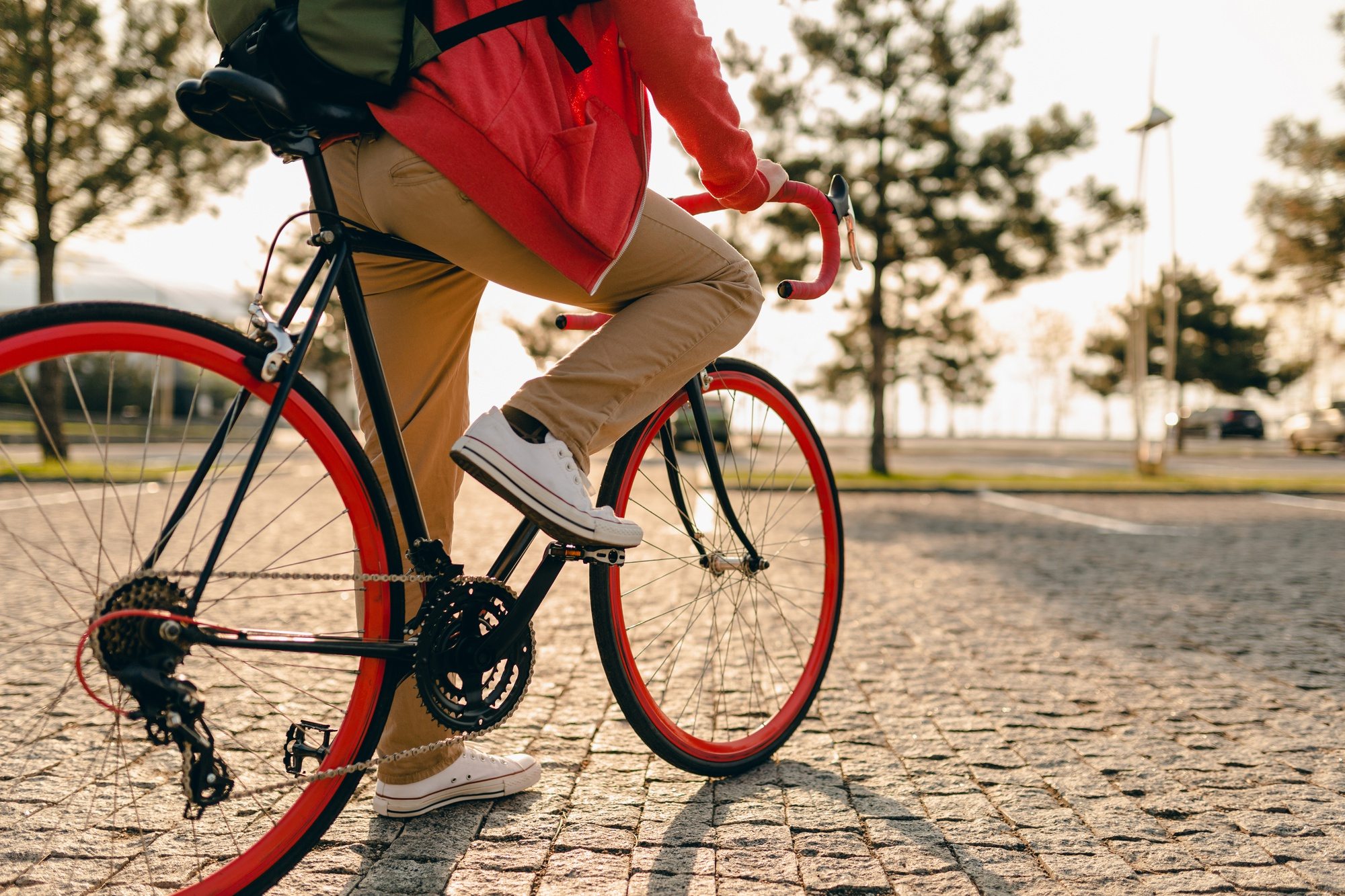 close-up-legs-sneakers-hands-steering-wheel-hipster-style-bearded-man-red-hoodie-beige-trousers-riding-alone-with-backpack-bicycle-healthy-active-lifestyle-traveler-backpacker
